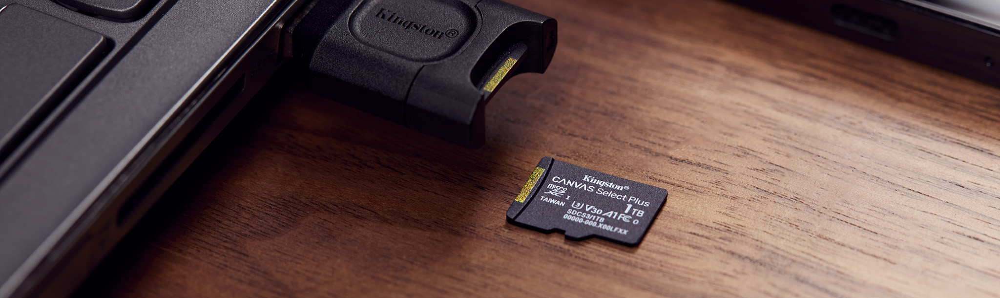 A 1TB Canvas Select Plus microSD placed on a table next to the Kingston MLP SD card reader