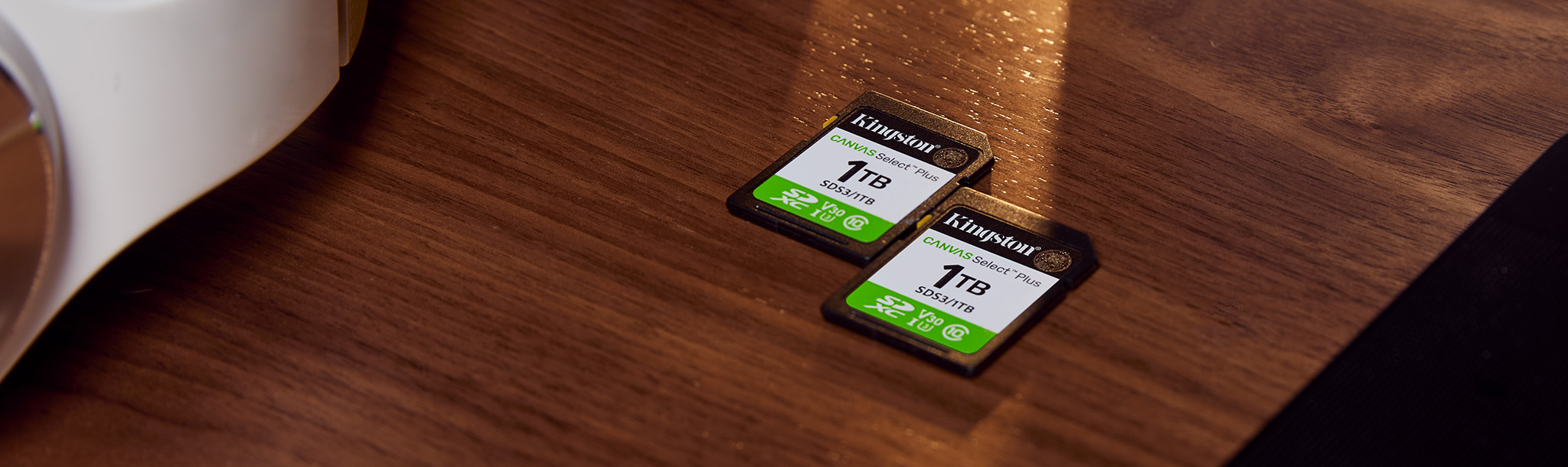 A pair of 1TB Canvas Select Plus SD cards placed on a tabletop