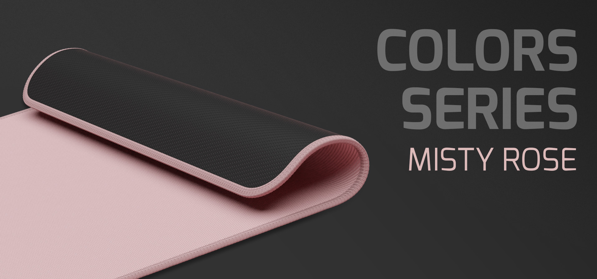 Mouse pad mare din seria Natec Colors, în culoarea roz cețos, cu o suprafață roz netedă și o margine neagră texturată.