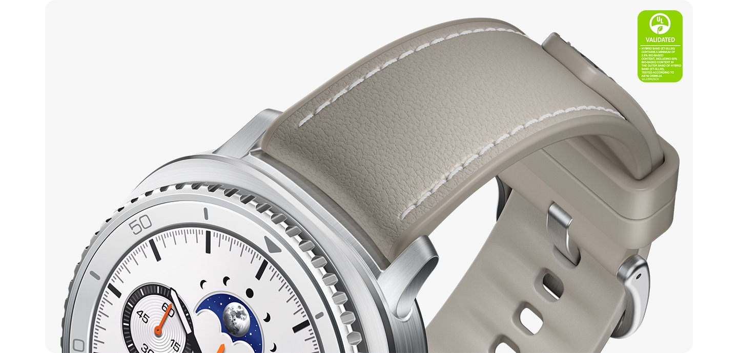 A close-up shot of the high-quality material on the Hybrid Band, which is attached to Galaxy Watch8 Classic. UL Validated symbol with the following text Hybrid Band (ET-SLL50) contains a minimum of 2.8% bio-based content, including 65% bio-based content in the outer band of Hybrid Band (ET-SLL50), tested according to ASTM D6866-24. UL.COM/ECV