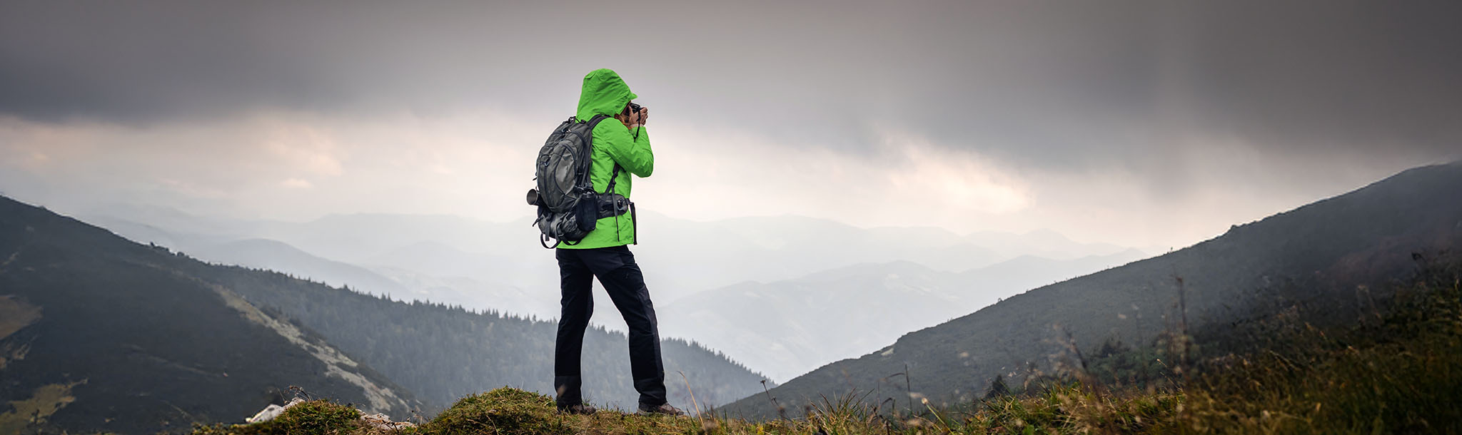 A photographer taking photos of a mountain range